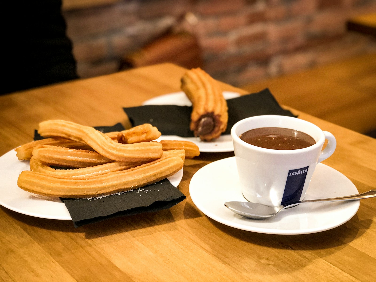 white ceramic cup with saucer and fries on brown wooden table